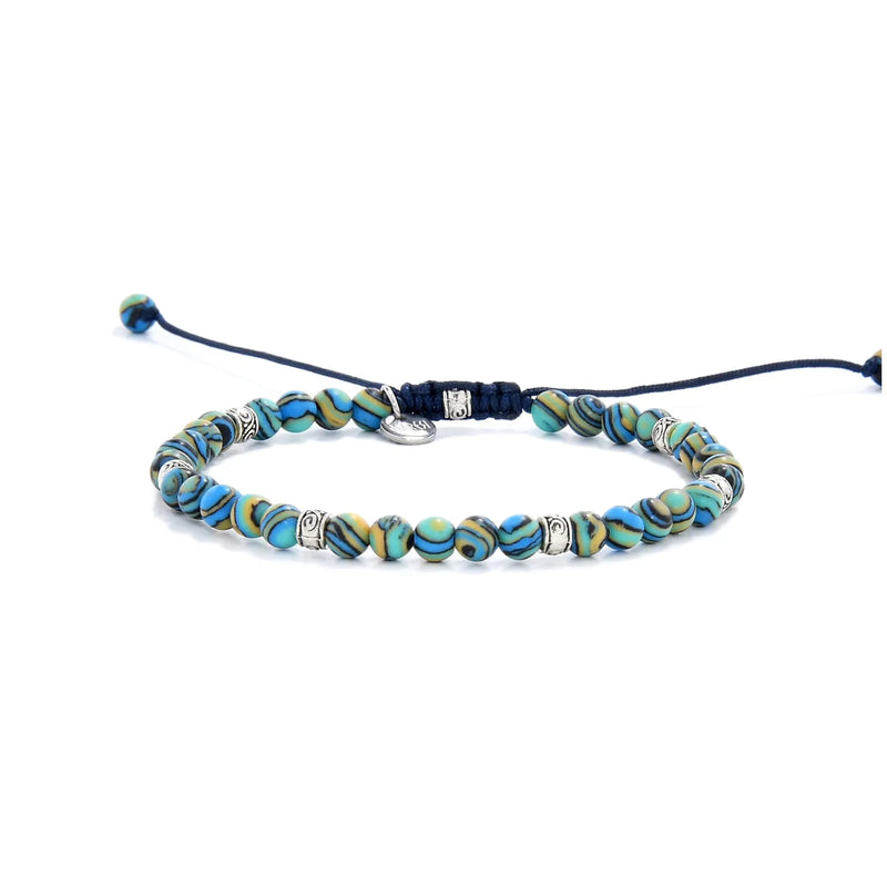 Bracelet Malachite full angled view with blue patterned beads, silver spacers, and drawcord closure