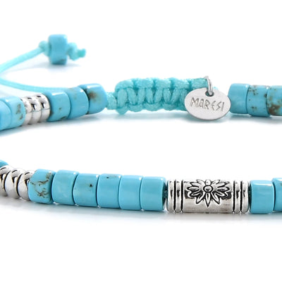 Detailed view of Bracelet of Clay with turquoise clay beads with engraved silver spacers, Shamballa clay bead texture, and