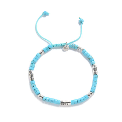 Bracelet of Clay shown from above with turquoise clay beads with engraved silver spacers and round bracelet shape