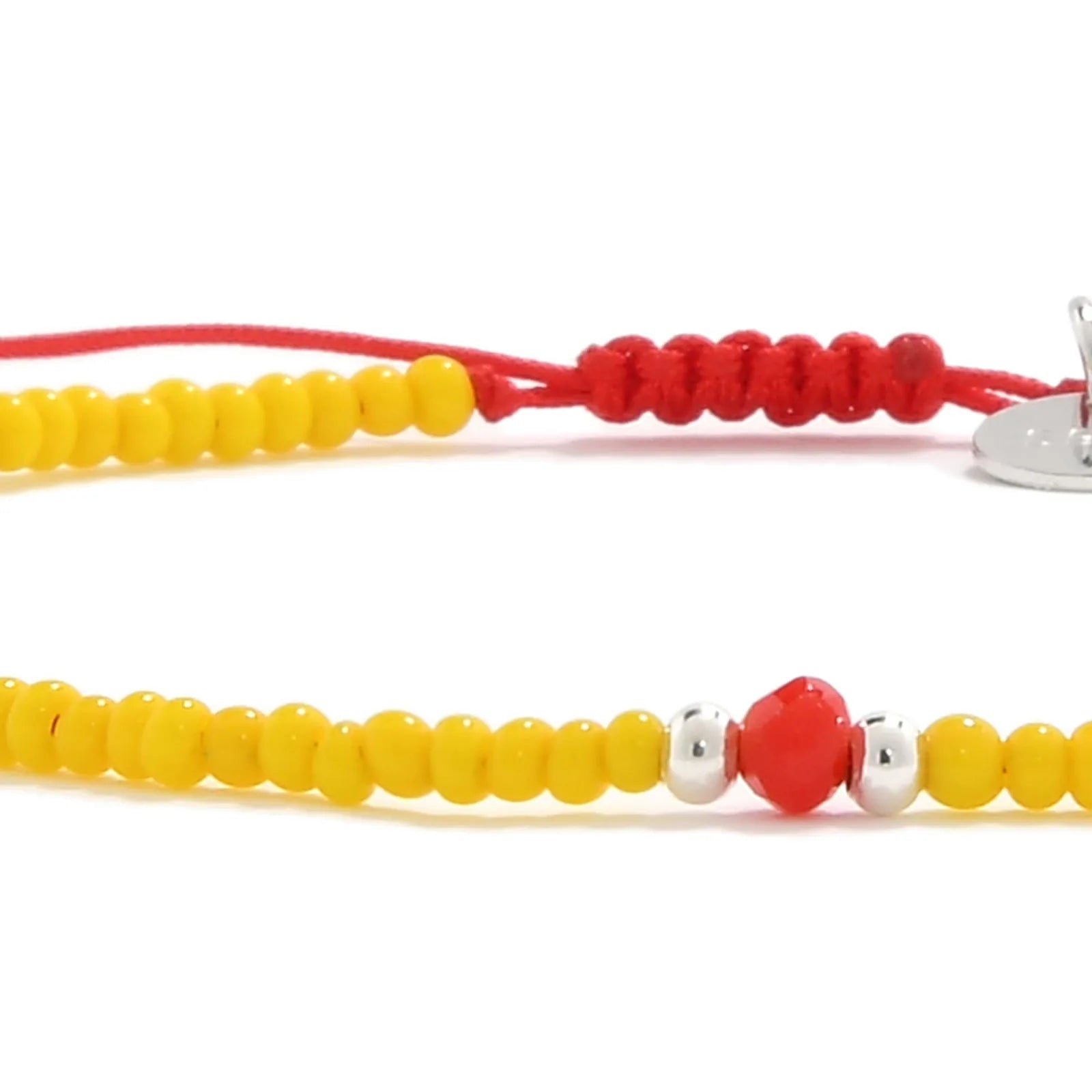 Detailed view of Bracelet with Glass Beads with yellow seed beads with red glass accents, seed bead texture, and cord knot