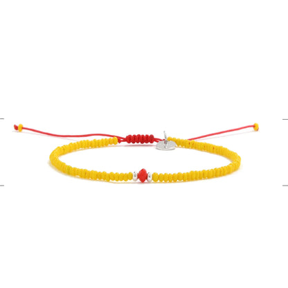 Bracelet with Glass Beads shown in full view with yellow seed beads with red glass accents and adjustable cord