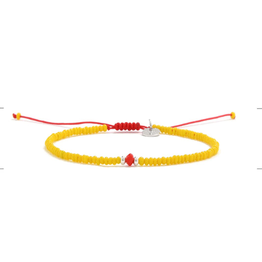 Bracelet with Glass Beads shown in full view with yellow seed beads with red glass accents and adjustable cord