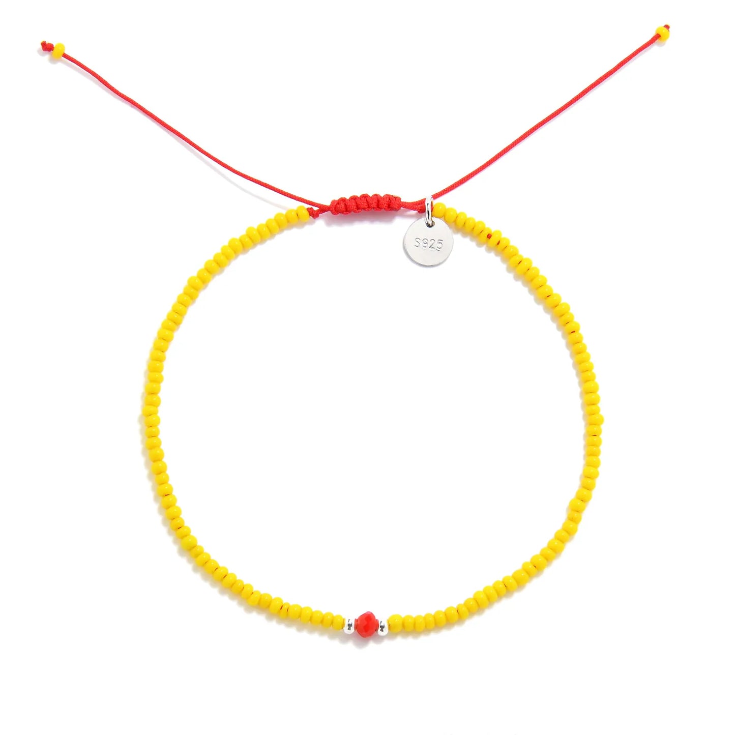 Bracelet with Glass Beads shown from above with yellow seed beads with red glass accents and round bracelet shape