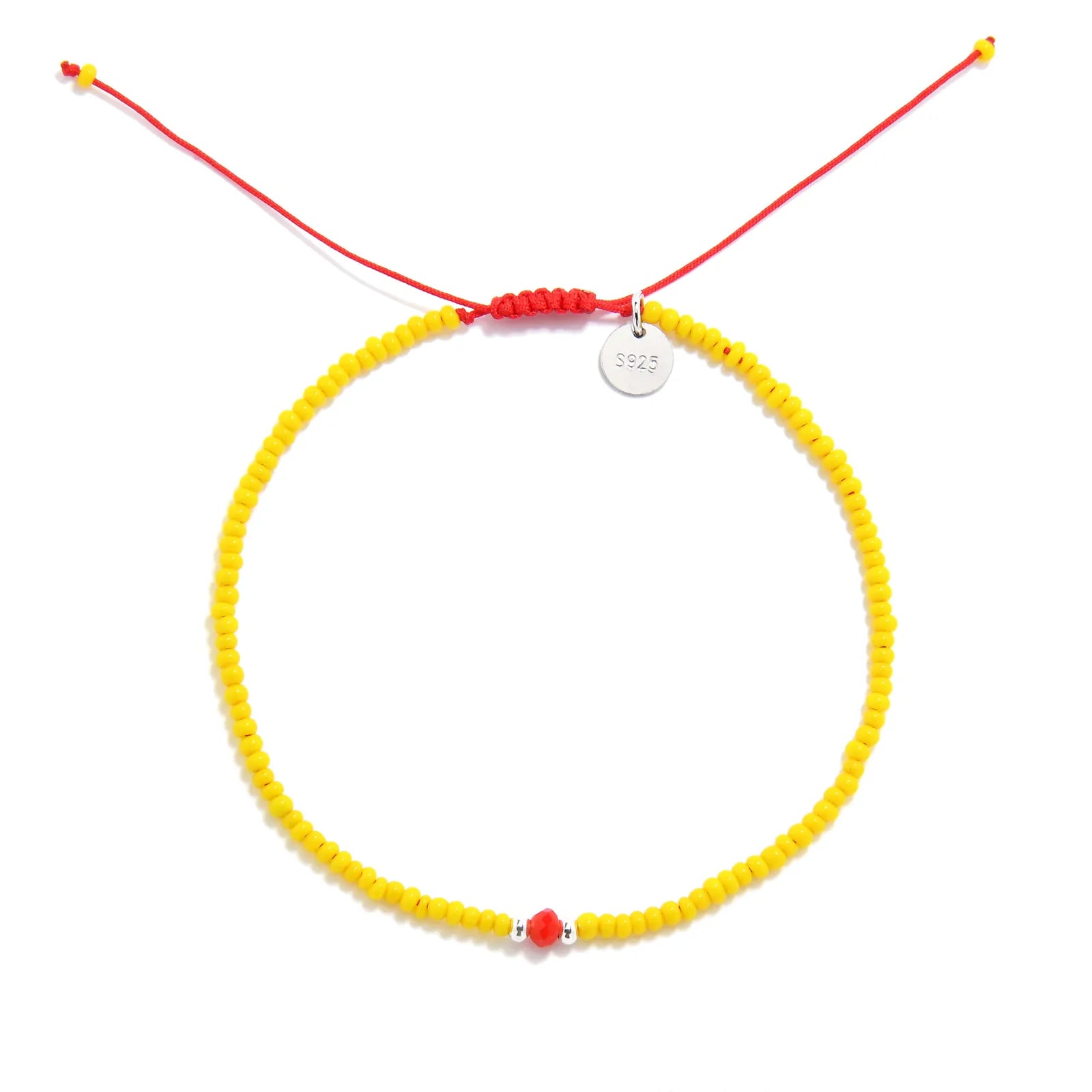 Bracelet with Glass Beads shown from above with yellow seed beads with red glass accents and round bracelet shape