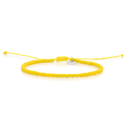 Bracelets Beads Essential shown in full view with yellow seed beads with silver charm and adjustable cord