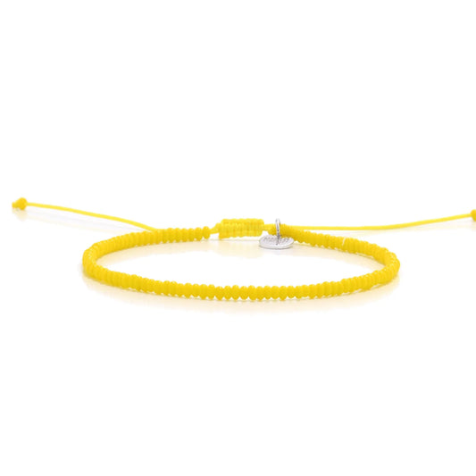 Bracelets Beads Essential shown in full view with yellow seed beads with silver charm and adjustable cord