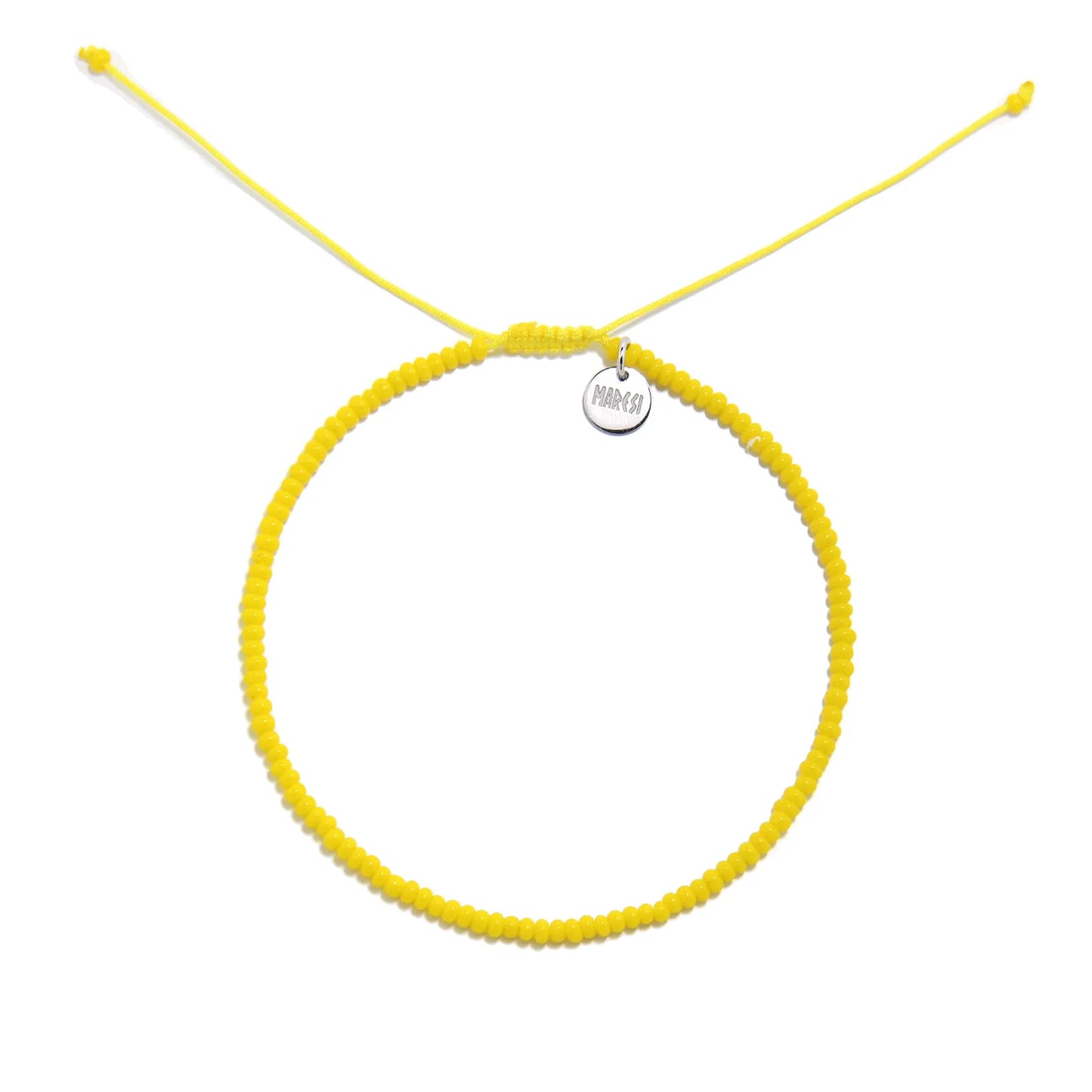 Bracelets Beads Essential shown from above with yellow seed beads with silver charm and round bracelet shape