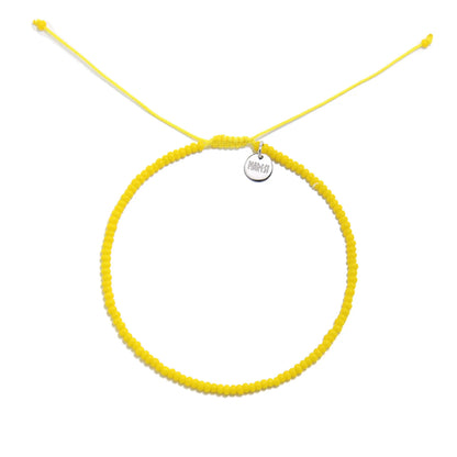 Bracelets Beads Essential shown from above with yellow seed beads with silver charm and round bracelet shape