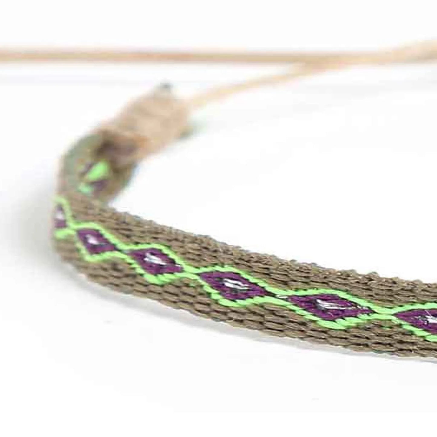 Detailed view of Braided Bracelet texture with olive cord, purple diamond pattern, and green detail