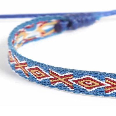 Detailed view of Braided Bracelets texture with blue cord, red diamond pattern, and cream accents