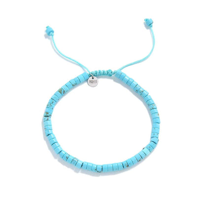 Clay Beads Bracelet shown from above with turquoise clay beads with silver charm and round bracelet shape