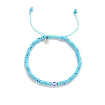 Clay Beads for Bracelets shown from above with turquoise clay beads with blue accent bead and round bracelet shape