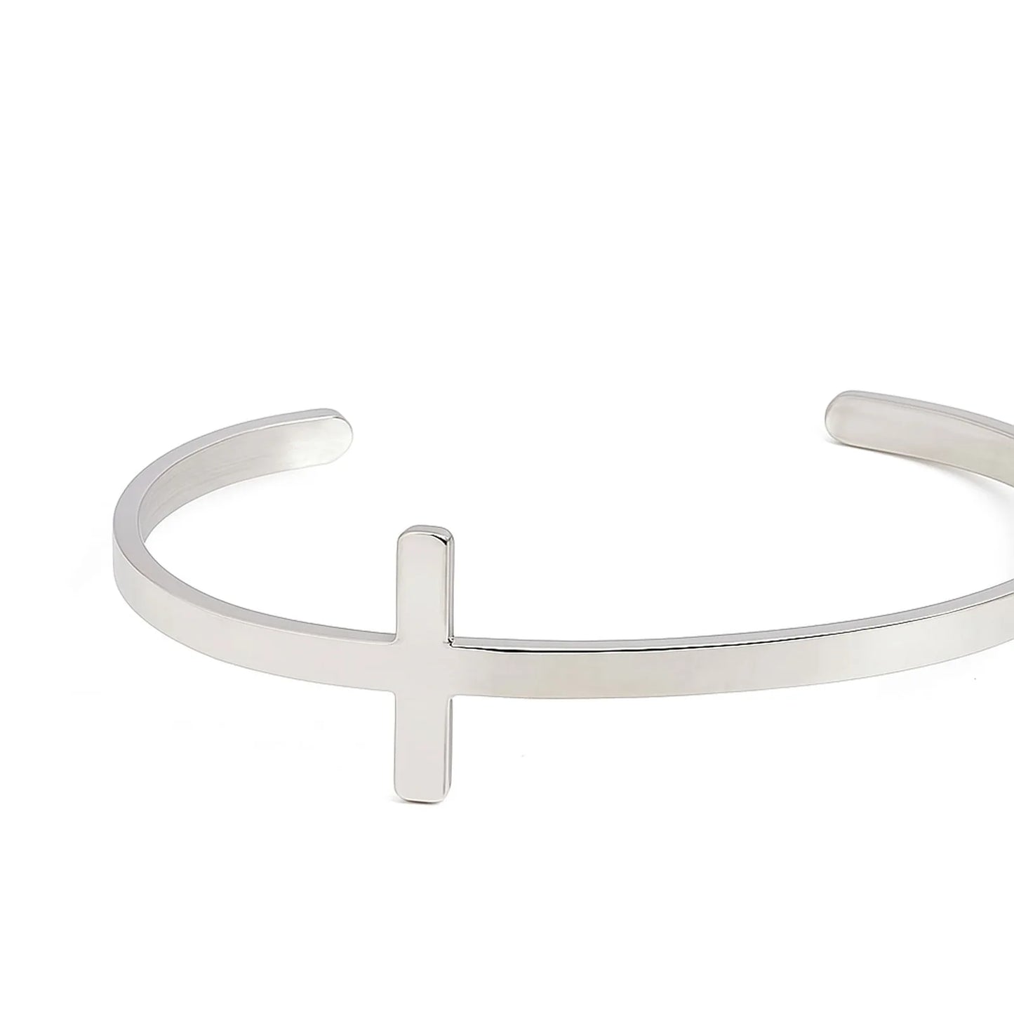 Close-up of cross bracelet showing raised cross centerpiece on a smooth polished cuff band