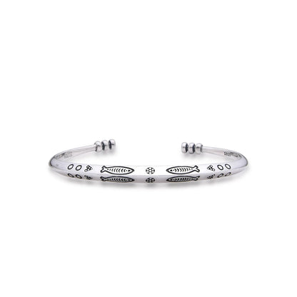 Cuff Bracelet with polished silver tone band, fish engravings, dotted details, and open ends