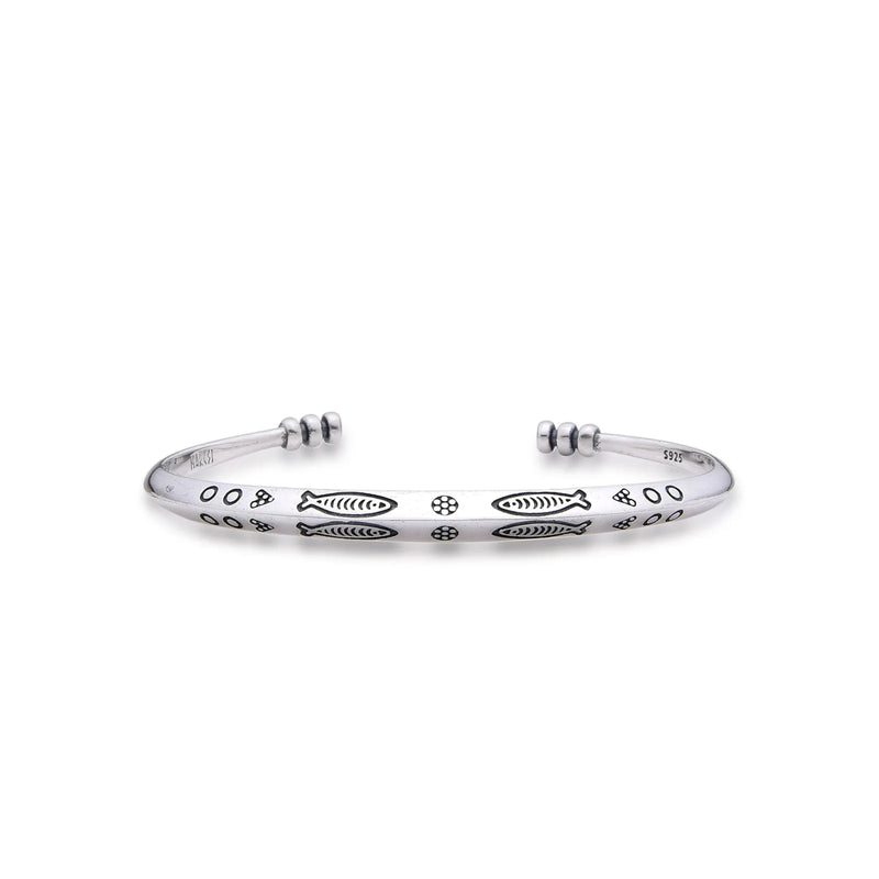 Cuff Bracelet with polished silver tone band, fish engravings, dotted details, and open ends