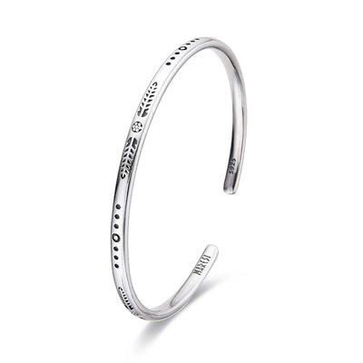 Cuff Bracelet for Men shown in angled profile with slim open shape and engraved symbols