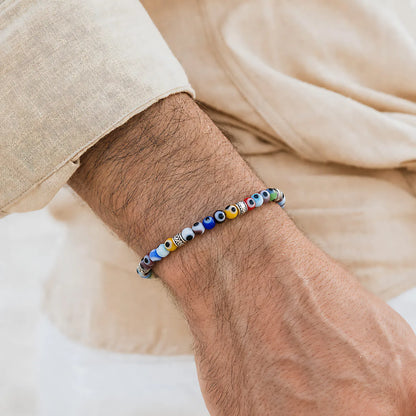 Evil Eye Bracelet for Men worn on a wrist with a light sleeve