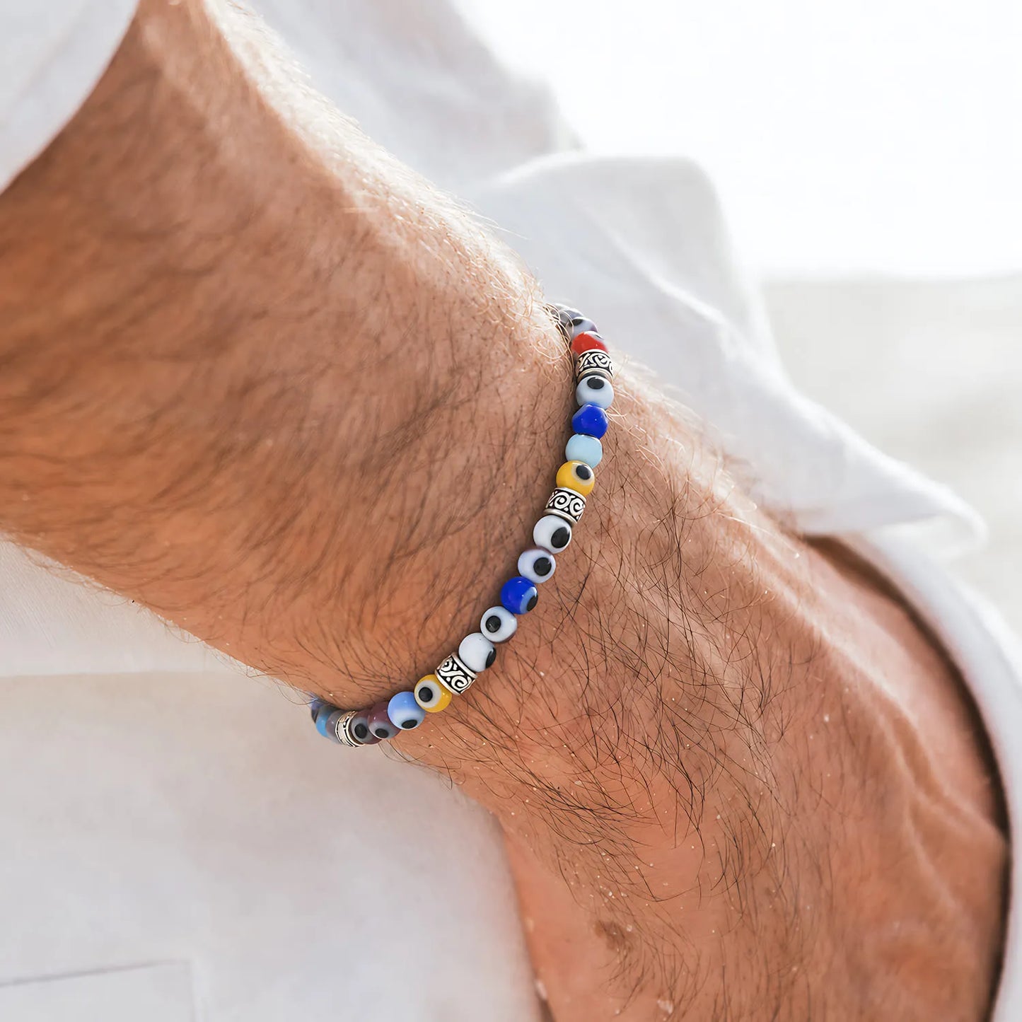 Evil Eye Bracelet for Men worn on a wrist with beaded design and adjustable cord