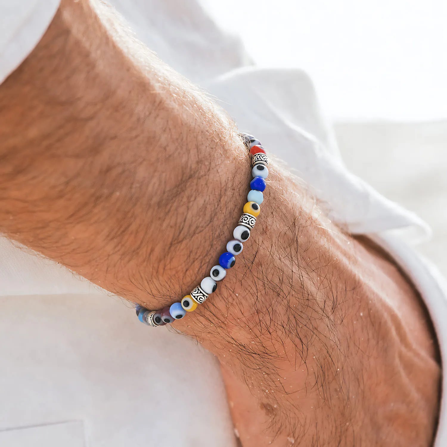 Evil Eye Bracelet for Men worn on a wrist with beaded design and adjustable cord