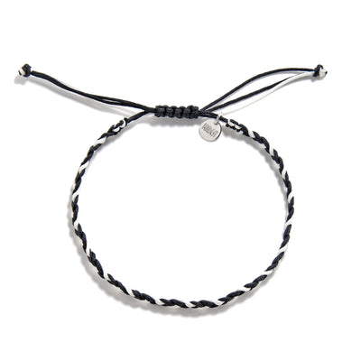 Friendship Woven Bracelet flat lay showing round woven cord and Maresi charm tag