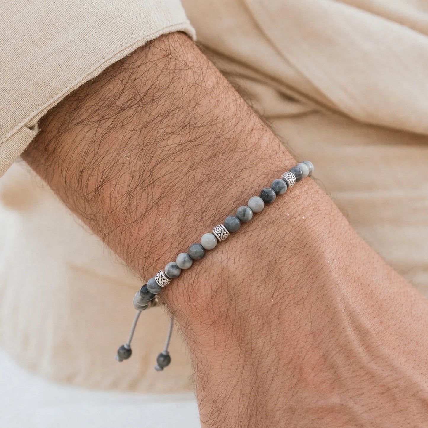 Gray Stone Bracelet worn on a wrist with a light sleeve