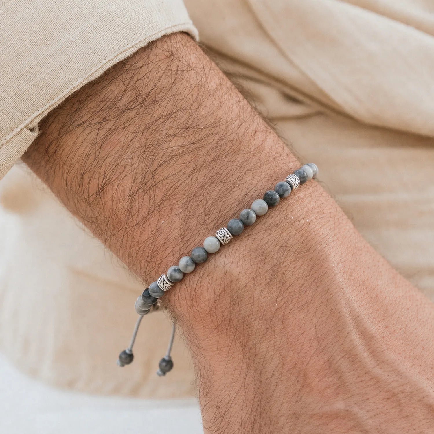 Gray Stone Bracelet worn on a wrist with a light sleeve