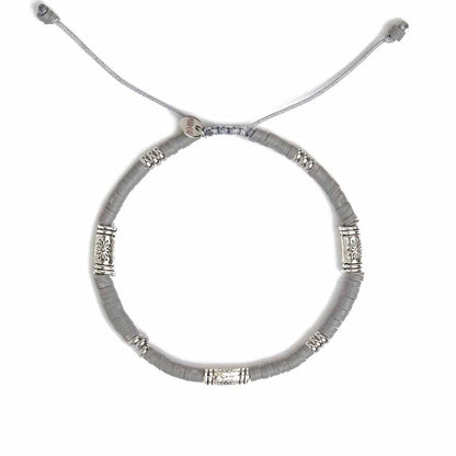 Flat-lay view of gray shamballa bracelet with silver accent spacers and adjustable cord