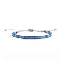 Handmade Bracelet in blue with turquoise and white woven pattern, gray cord, and silver bead ends