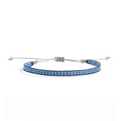 Handmade Bracelet in blue with turquoise and white woven pattern, gray cord, and silver bead ends