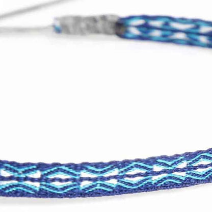 Detailed view of Handmade Bracelet texture with blue cord, turquoise pattern, and silver cord wrap
