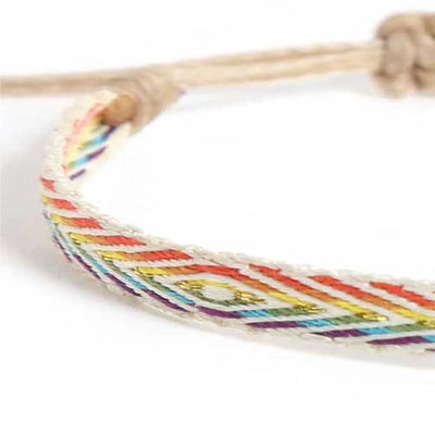 Detailed view of Handmade Bracelets texture with white cord, rainbow pattern, and beige closure