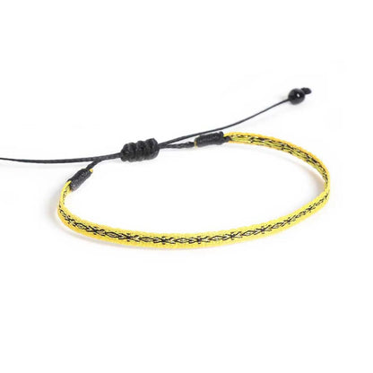 Handmade Mens Bracelets shown from above with yellow patterned band and black sliding knot closure