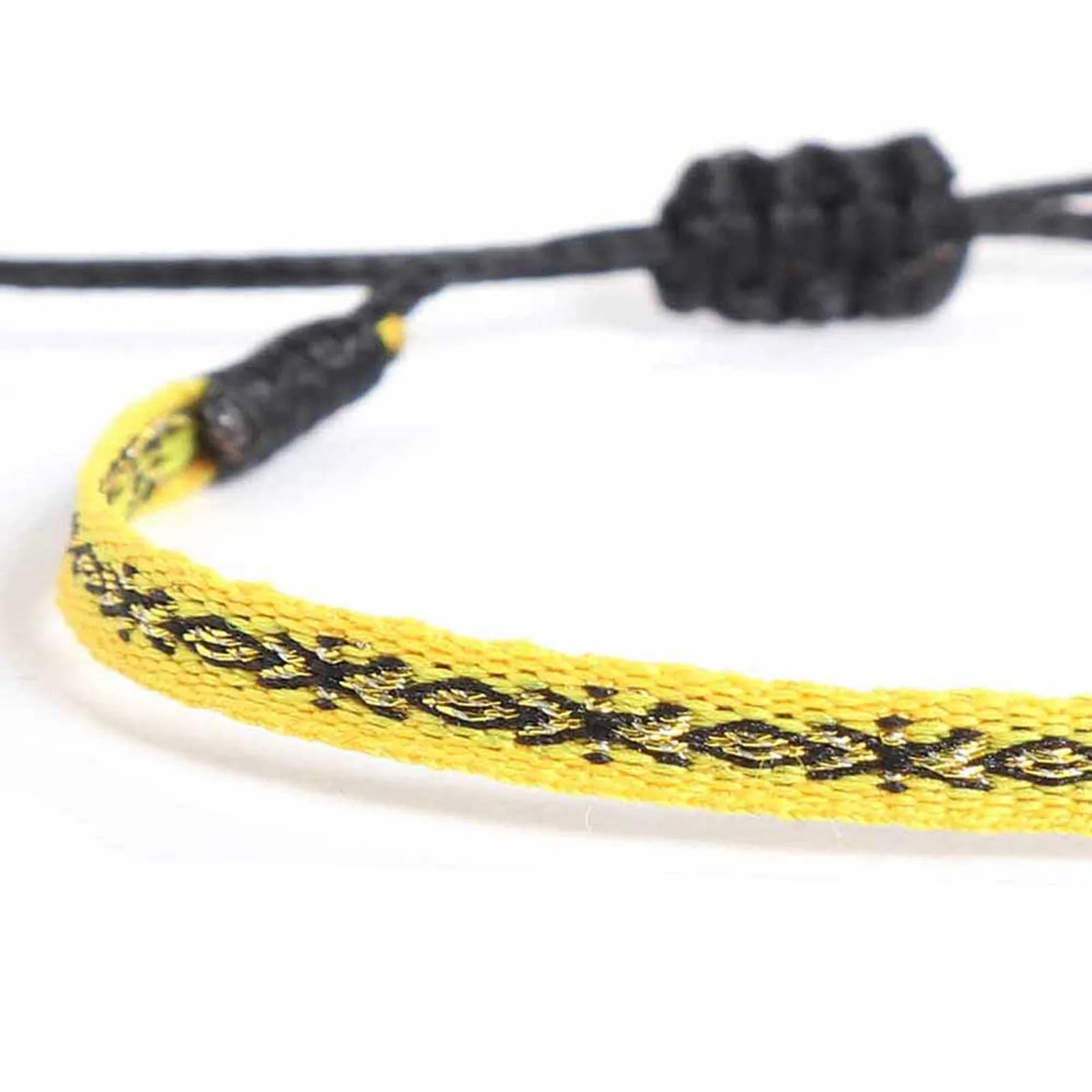 Close-up of Handmade Mens Bracelets with yellow woven band, black pattern, and black cord closure