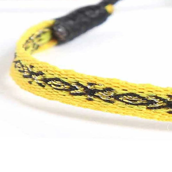 Detailed view of Handmade Mens Bracelets texture with yellow cord and black embroidered pattern