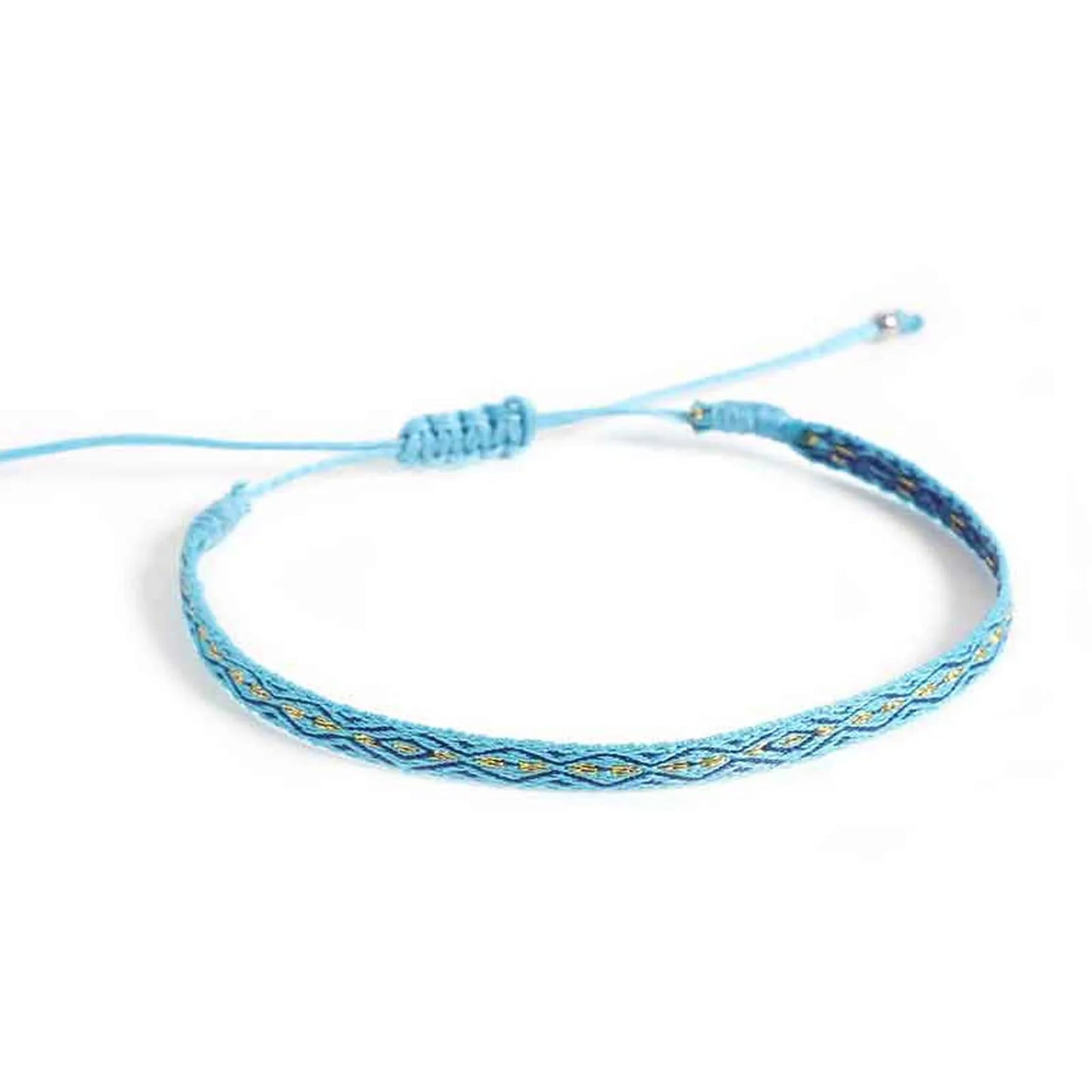 Handmade rope bracelet shown from above with blue cord, sliding knot closure, and patterned band