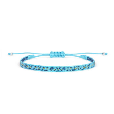 Handmade rope bracelet in bright blue with navy and gold woven pattern, adjustable cord, and bead ends