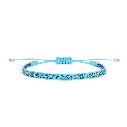 Handmade rope bracelet in bright blue with navy and gold woven pattern, adjustable cord, and bead ends