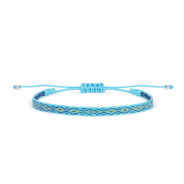 Handmade rope bracelet in bright blue with navy and gold woven pattern, adjustable cord, and bead ends