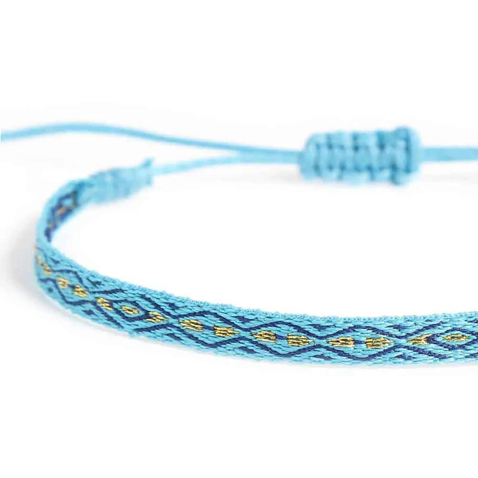 Close-up of handmade rope bracelet with blue woven band, navy lines, and small gold accents