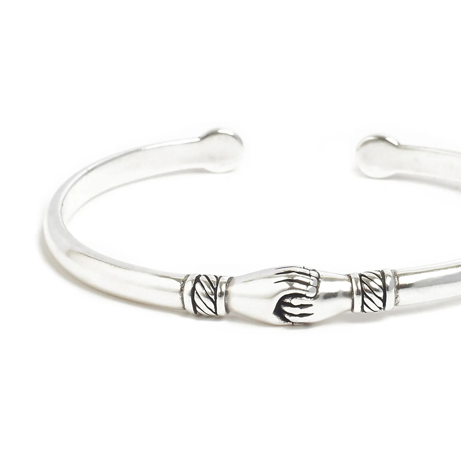 Close-up of handshake bracelet showing handshake centerpiece and carved line details