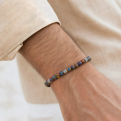 Malachite Color Bracelet worn on a wrist with beaded design and adjustable cord