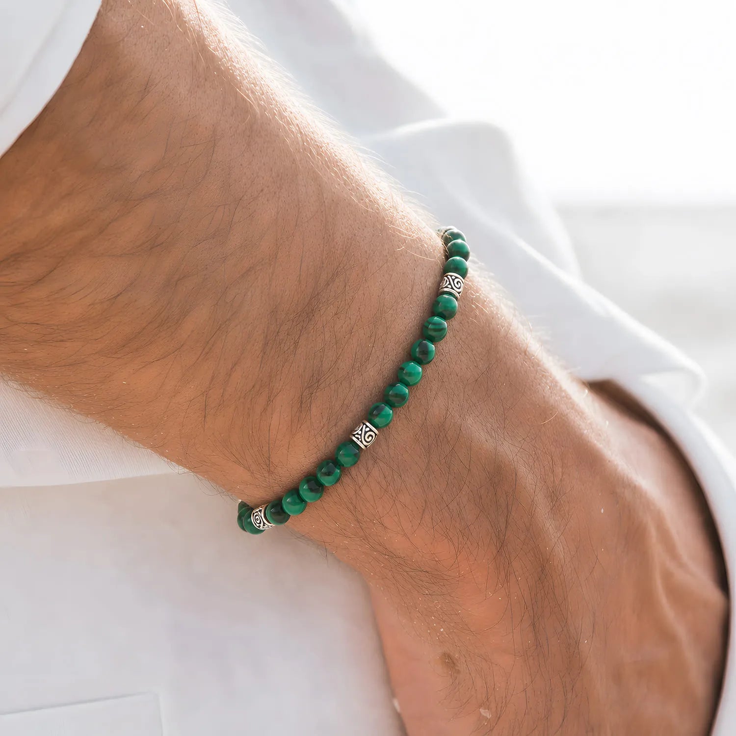 Malachite Jewelry worn on a wrist with beaded design and adjustable cord