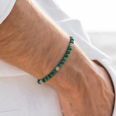 Malachite Jewelry worn on a wrist with beaded design and adjustable cord