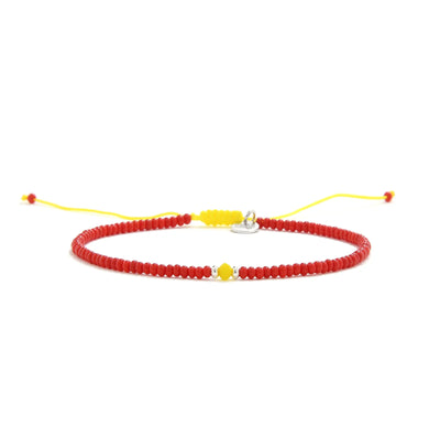 Man Bracelet Beads shown in full view with red seed beads with yellow accent beads and adjustable cord