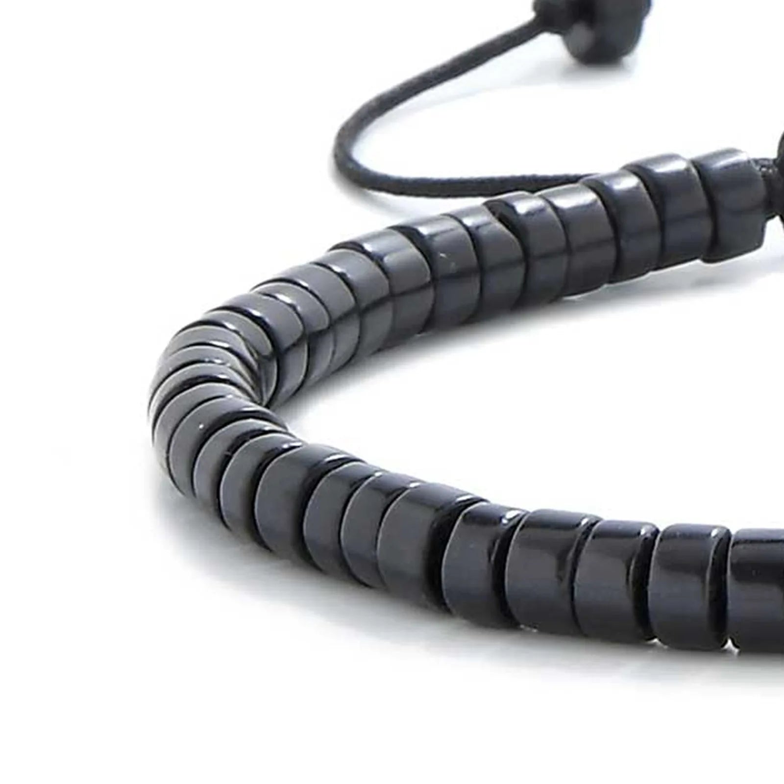 Detailed view of matte black bracelet , clay bead texture, and cord knot