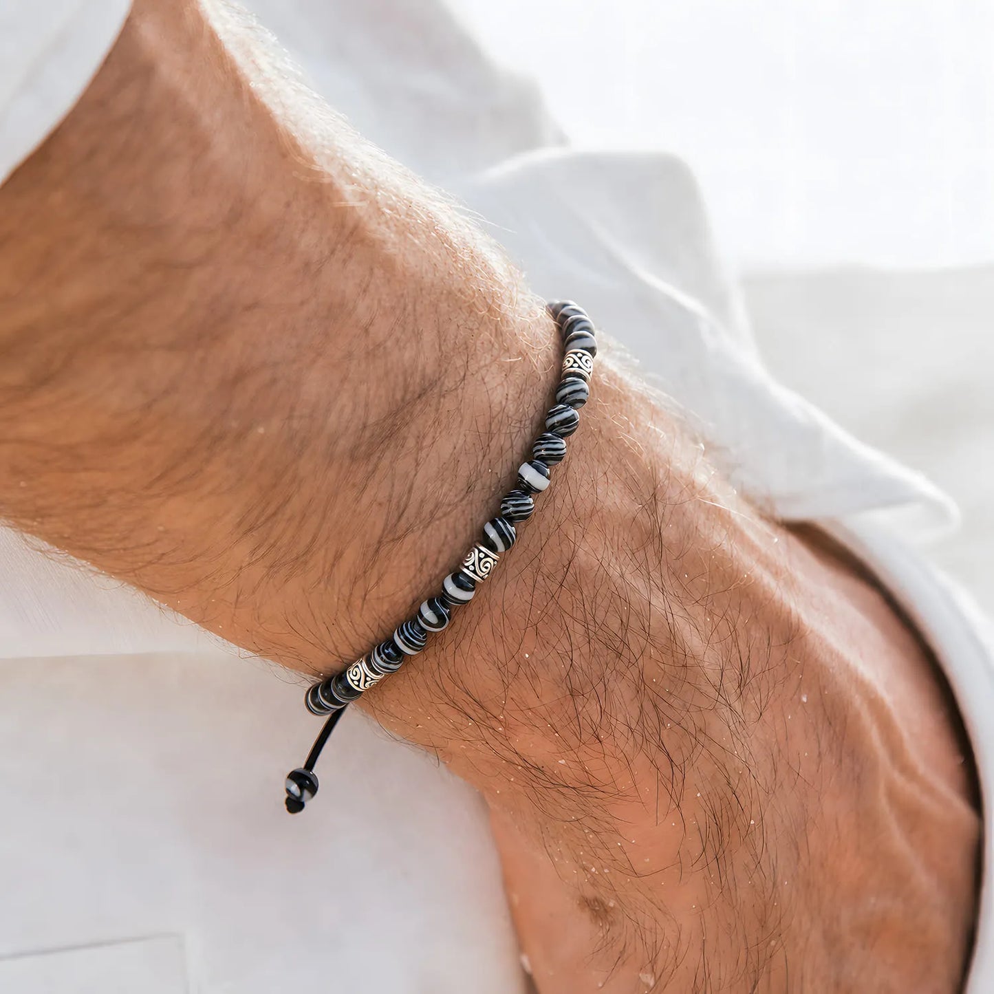 men’s malachite bracelet worn on a wrist with beaded design and adjustable cord