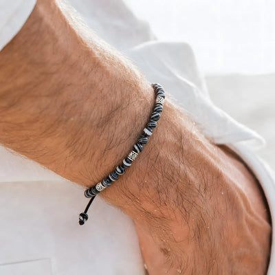 men’s malachite bracelet worn on a wrist with beaded design and adjustable cord