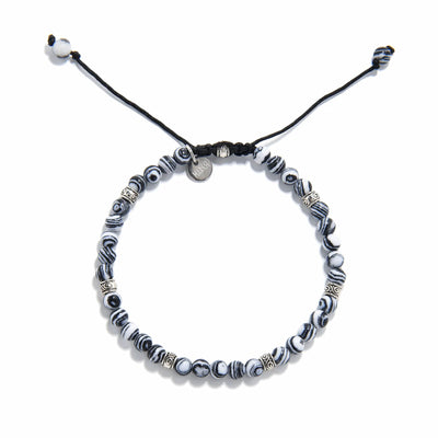 men’s malachite bracelet laid flat, showing circular pattern and woven cord clasp