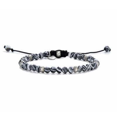 Full view of men’s malachite bracelet featuring striped black and white beads with silver spacers.
