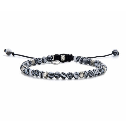 Full view of men’s malachite bracelet featuring striped black and white beads with silver spacers.